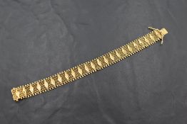 An 18ct gold multi-linked bracelet with lozenge decoration, marked 750, 17.5cm overall, 22grams
