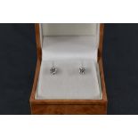 A pair of 18ct gold diamond solitaire earrings, the claw-set diamond brilliants measuring 0.20cts