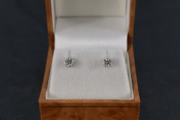 A pair of 18ct gold diamond solitaire earrings, the claw-set diamond brilliants measuring 0.20cts