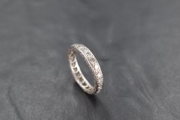 A diamond and platinum full eternity ring having 21 diamonds, total approx 1ct in a pave mount