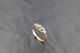A diamond chip set band ring having a wave style pave set mount on yellow metal loop stamped 18K,