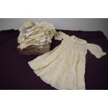A selection of babies and children's clothing, including silk dresses, some beautiful detailed