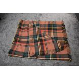 A large vintage Otterburn rug, in a beige, cream, yellow, blue, red and green check, some wear and a