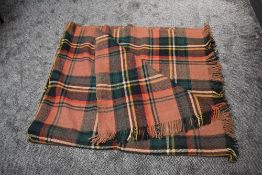 A large vintage Otterburn rug, in a beige, cream, yellow, blue, red and green check, some wear and a