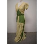 A 1930s green taffeta and lace evening gown having buttons to rear and deep neckline.