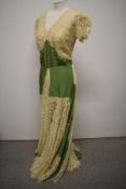 A 1930s green taffeta and lace evening gown having buttons to rear and deep neckline.