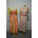 Two early 20th century dresses, comprising lawn cotton dress with frilled skirt and ladder work to