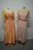 Two early 20th century dresses, comprising lawn cotton dress with frilled skirt and ladder work to