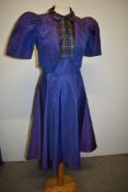 A 1940s purple watered taffeta dress having faux bolero covering an integrated tartan bodice with