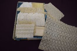 A box full of mixed antique lace work, various styles and techniques used throughout.