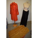 An early 20th century coral silk coat having tie detail to neck and textured panels to collar, cuffs
