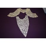 An antique handmade lace modesty panel and a collar, both highly decorative and finely executed.