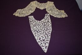 An antique handmade lace modesty panel and a collar, both highly decorative and finely executed.