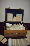 A leather suitcase containing an extensive amount of varied antique lace, trimmings, edgings and