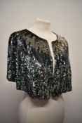 An Art Deco sequinned bolero having blue, gold and silver tone phased sequin detail.
