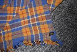 A large Otterburn rug, in a blue, beige, red and cream colourway, some wear and a few small