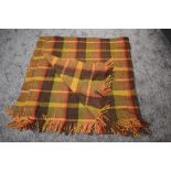 A large vintage Otterburn rug, in a brown, beige, red and green colourway, some wear and a few small