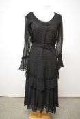 A black 1930s Art Deco evening dress having stitched detailing to bodice and upper portion of tiered
