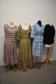 A mixed lot of vintage and retro dresses and a jumper.