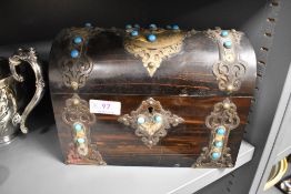 A mid Victorian dome topped chest tea caddy having brass banding and azure blue cabochon decoration.