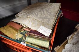 A box of mixed fabric and textile samples.