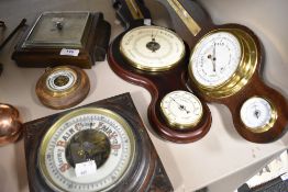 Five vintage barometers including an Edwardian example having carved oak frame with an enamel dial.