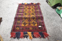 A 20th century Persian Afghan Belouch saddle bag in woven wool in a brown and red ground with