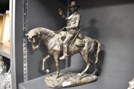 A 20th century Arnoux Paris cast bronze sculpture of a cowboy on horse back. 37cm tall.