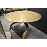 A 20th century tripod table with Kudu horn supports with an Indian brass chase worked table top with