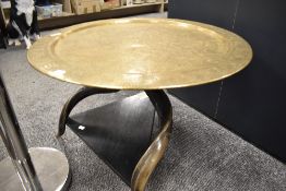 A 20th century tripod table with Kudu horn supports with an Indian brass chase worked table top with
