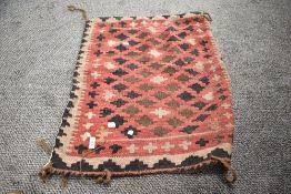 A 20th century Persian Afghan Balouch saddle bag in woven wool in a cream and red ground 80cm x