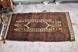A vintage saddlebag rug, having traditional pattern, In darker tones.