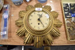 An early 20th century Smiths star burst design wall clock, having damage.