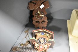 Two small sized wooden cased Cuckoo clocks.