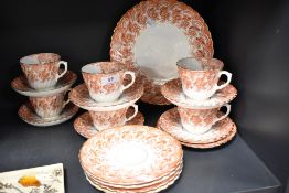 A Victorian porcelain part tea service having red and gilt transfer design.