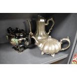 An antique pumpkin form pewter tea pot with a similar coffee pot and a Victorian teapot having a