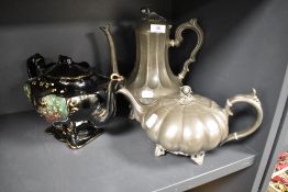 An antique pumpkin form pewter tea pot with a similar coffee pot and a Victorian teapot having a