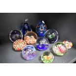 A selection of modern art glass paper weights including millefiori, two by Caithness and a lamp