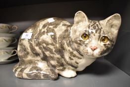 A Jenny Winstanley ceramic figure of a Tabby cat crouching, bearing signature to base. 32cm long.