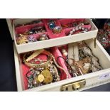 A jewellery box containing a selection of vintage costume jewellery, including loose beads, rings,