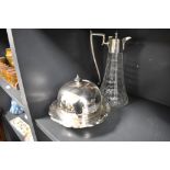 An early 20th century muffin dish with a cut glass claret jug having silver plated handle and lid.