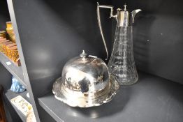 An early 20th century muffin dish with a cut glass claret jug having silver plated handle and lid.