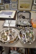 A large collection of silver plated serving wares including lidded dishes, cutlery, condiment sets