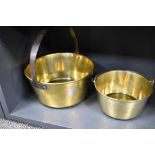 Two brass jam pans one having a fixed handle and one with swing handle