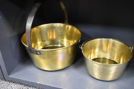 Two brass jam pans one having a fixed handle and one with swing handle
