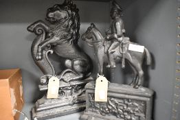 Two Victorian cast iron door stops or fire ornaments one in the form of a rampant lion and the other