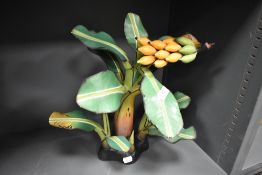A modern hand carved wooden sculpture of a banana plant. 35cm tall.