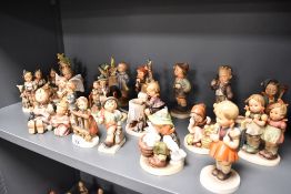 Twenty Three Goebel Hummel figures and figurines in varying poses and subjects, all in good