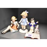 Three Goebel figurines having early bee stamps including Child and Poodle Reading, Girl Playing