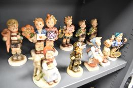 Six early Goebel Hummel figures and figurines bearing the large Bee stamp to base, plus a final